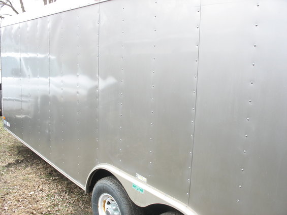 Silver enclosed trailer side view with rivets