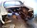 1969 Ford Mustang - The rear of a 1969 Ford Mustang is shown disassembled, with the trunk and suspension components exposed.