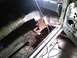1969 Ford Mustang - Car interior with extensive rust damage on the floor, undergoing repair work.