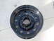1986 Ford Bronco - A single black steel wheel is shown resting on a concrete surface.