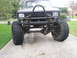 1984 Ford Bronco II - This heavily modified SUV features oversized tires and a prominent front brush guard.