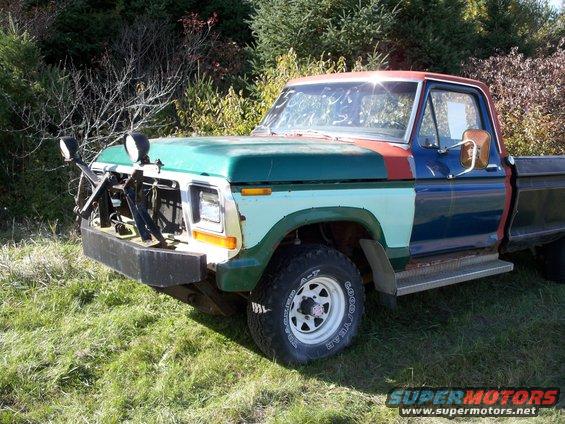 Pickup truck with mismatched paint panels and auxiliary lights on the front