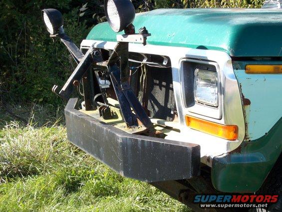 Front view of a 1980s Ford F-Series truck with a plow mount and auxiliary lights
