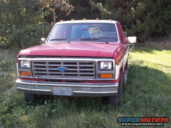 Front view of a red and white 1987 Ford F-150 pickup truck