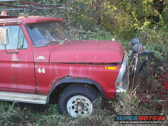 Red truck with rust on fender, number 44 on door, and a "Ford" badge