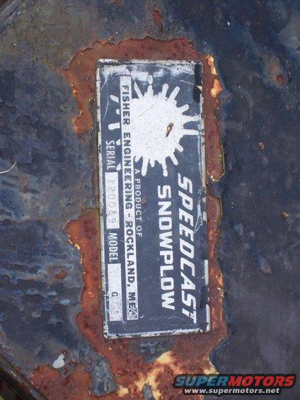Rusted metal surface with a Speedcast Snowplow data plate, showing Fisher Engineering, Rockland, ME