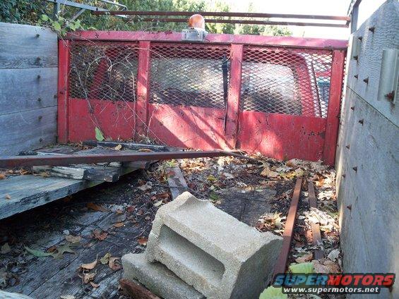 Red truck bed interior with diamond plate metalwork and wooden sides
