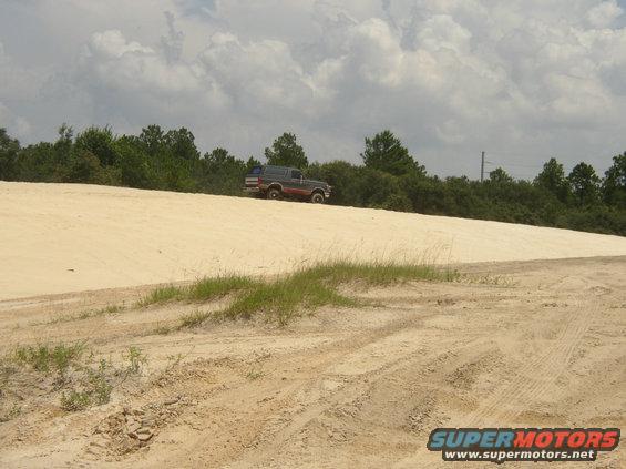1991 Ford Bronco driving on a sand dune