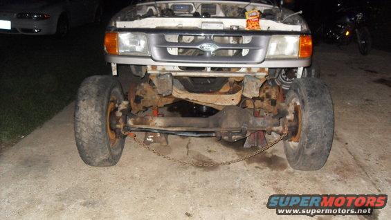 Front view of a 1997 Ford Ranger with the hood up and front wheels removed