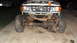 1997 Ford Ranger - The front axle and suspension of a 1997 Ford Ranger are visible, with the vehicle supported by jack stands.