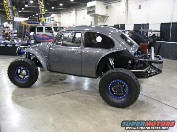 Custom gray VW Beetle dune buggy with big off-road tires and exposed engine