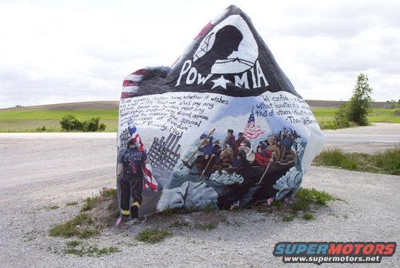 Memorial rock painted with POW-MIA symbol, Washington crossing the Delaware, and quotes