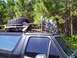 1994 Ford Bronco - 1994 Ford Bronco with a roof rack loaded with a spare tire and shovel, plus several spotlights.