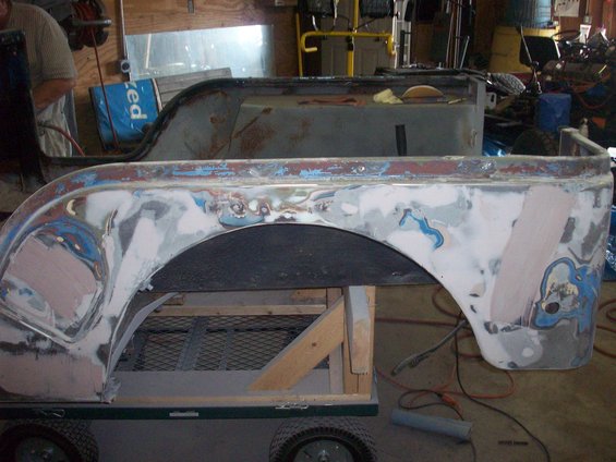 Jeep CJ5 rear quarter panel undergoing bodywork with primer and filler