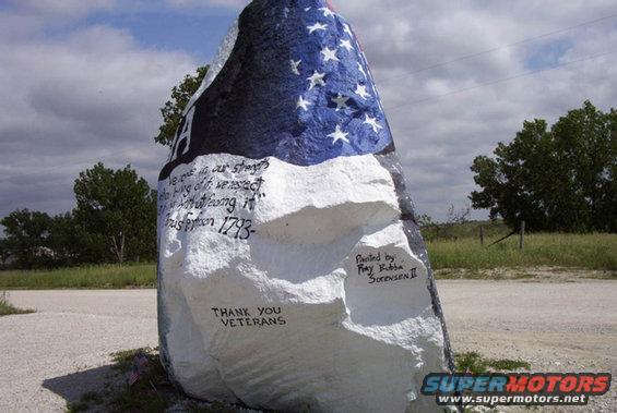 Painted rock with American flag and text reading 'We owe in our strength the King of... ' and 'Thank You Veterans'