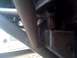 1989 Ford Bronco - This image shows a close-up of a vehicle's undercarriage, focusing on frame and suspension elements.