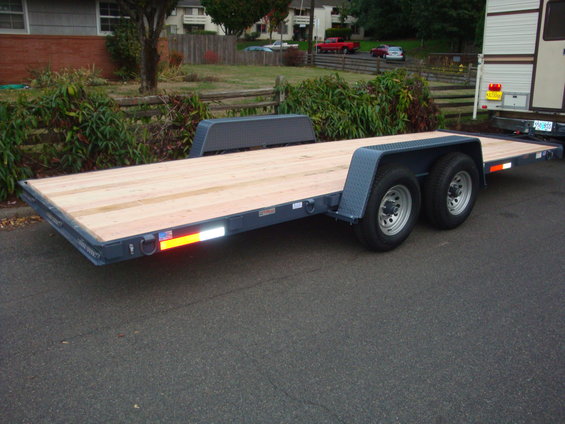 Flatbed trailer with wooden deck and dual axles
