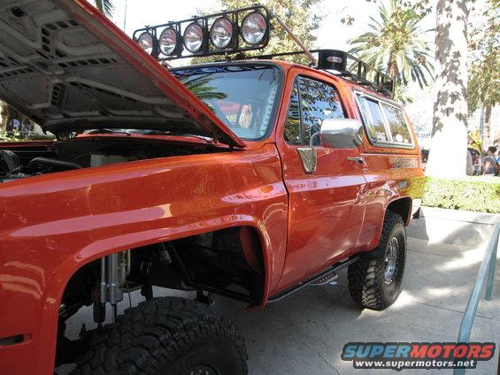 1986 Ford Bronco with hood open, roof lights, and off-road tires