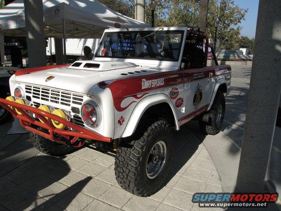 White and red Ford Bronco with off-road tires and a brush guard