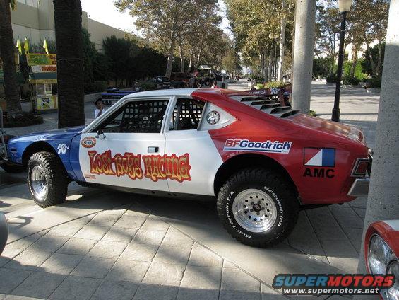 Custom AMC Pacer with 'Lost Boys Racing' decals, BFGoodrich tires, and roll cage, viewed from the side