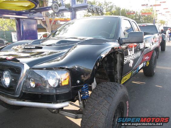 Black off-road truck with custom bodywork, large tires, and 'Hamburg' graphics