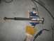 1995 Ford F-150 - A drive shaft is secured in a vise, ready for welding or modification. Welding gear and protective gloves are visible.