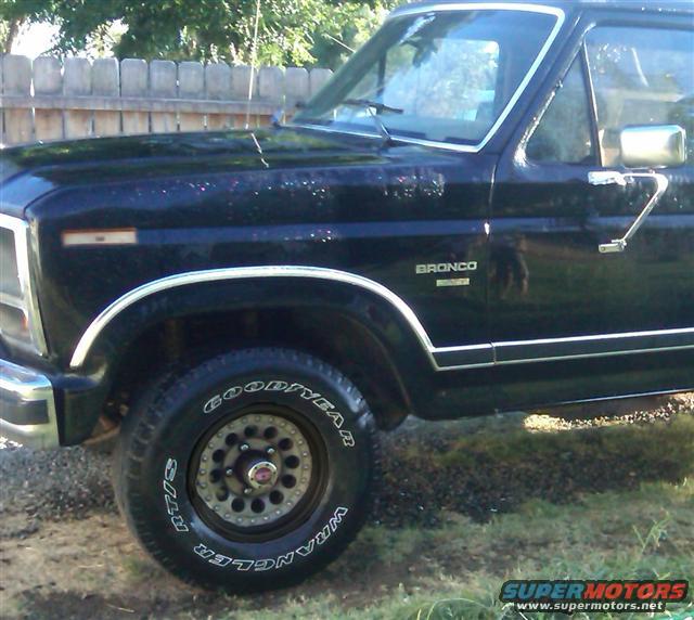 Front fender of a black Ford Bronco with Goodyear Wrangler tire