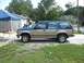 1992 Ford Explorer - A 1992 Ford Explorer SUV is seen from the side, parked in front of a house with a blue tent nearby.