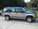 1992 Ford Explorer - This two-tone 1992 Ford Explorer is shown from the side, parked on a concrete driveway.