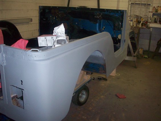 Gray primed Jeep CJ-5 body on a cart, interior visible