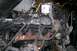 1992 Ford C-350 (Centurion Conversions) - Engine assembly, likely undergoing maintenance or replacement, is suspended by a chain hoist. A prominent oil filter is visible.