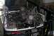 1992 Ford C-350 (Centurion Conversions) - The engine is suspended by a chain and hoist, ready for removal from the engine bay.