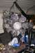 1992 Ford C-350 (Centurion Conversions) - An engine assembly is shown suspended by a chain hoist, with a large fan and belts visible.