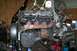 1992 Ford C-350 (Centurion Conversions) - Engine and transmission assembly suspended by an engine hoist in a garage setting.