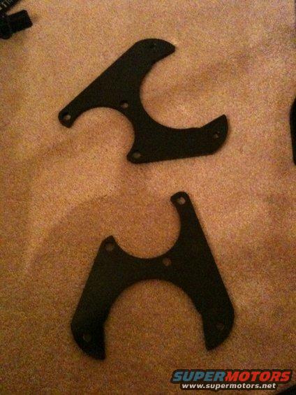 Two black metal brackets on carpet