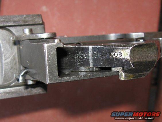 Close-up of a metal part with stamped numbers '564008'
