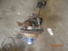 1991 Ford F-150 - A rusty front axle assembly with a brake rotor and blue hub is shown on a concrete floor.
