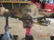 1991 Ford F-150 - Rear axle differential assembly on jack stands in a workshop setting.