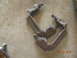 1991 Ford F-150 - Two brake caliper brackets are shown on a concrete floor.