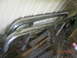 1991 Ford F-150 - Chrome side steps are stored outdoors, leaning against a corrugated metal wall.