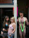 1970 Mercury Cougar - A man in a green mankini poses with two women outside a building with text above.