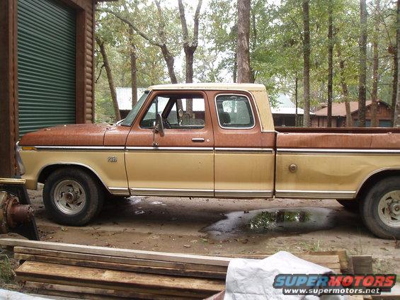 1975 Ford F-250 pickup truck parked next to a garage