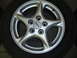 1993 Ford Probe - Close-up of a silver alloy wheel with ABS branding, mounted on a tire.