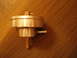 1993 Ford Probe - Metal fuel filter with brass fittings, shown on a wooden surface.