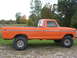 1975 Ford F-250 - Side profile of a lifted 1975 Ford F-250 pickup truck with orange paint.