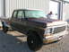 1975 Ford F-250 - This 1975 Ford F-250 pickup truck features a crew cab and a long bed, parked outdoors.