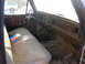 1975 Ford F-250 - The interior of a 1975 Ford F-250 shows wear and tear, with a pack of cigarettes on the seat.