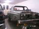 1984 Chevrolet Blazer - A green SUV is in a garage with its front end disassembled, supported by yellow jack stands.