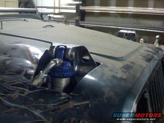 Close-up of custom front suspension with blue coilover shock on a Jeep YJ