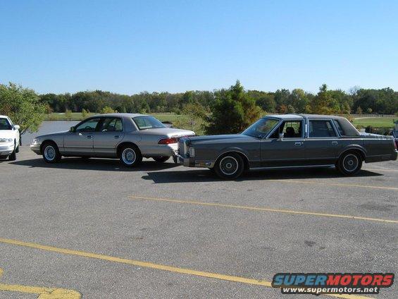 Gray Lincoln Town Car and silver Mercury sedan parked side-by-side